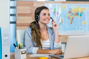 Pretty travel agent speaking to customer in the office